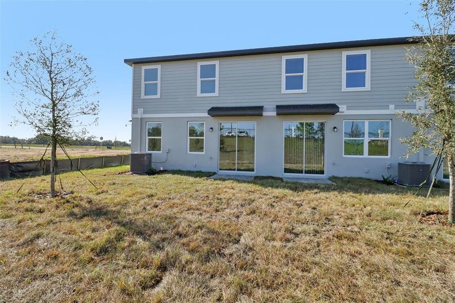 Exterior details and patio area of a home in The Reserve at Hammock Oaks Townes, Lady Lake (Image 20).