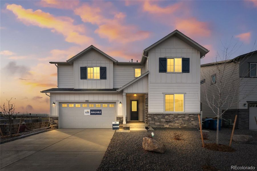Front exterior of a new home in Harvest Crossing, Aurora, CO, highlighting curb appeal (Image 1).