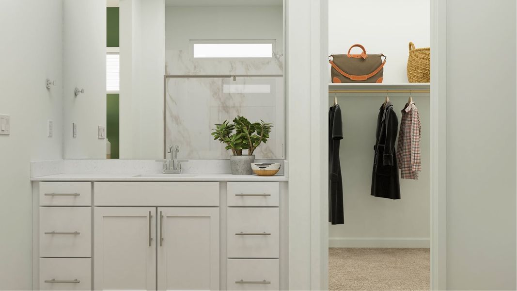 Owners bathroom sink and closet entrance