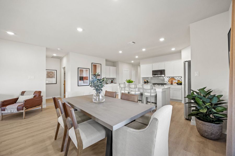 A large kitchen with a dining table. A large kitchen with a dining table.