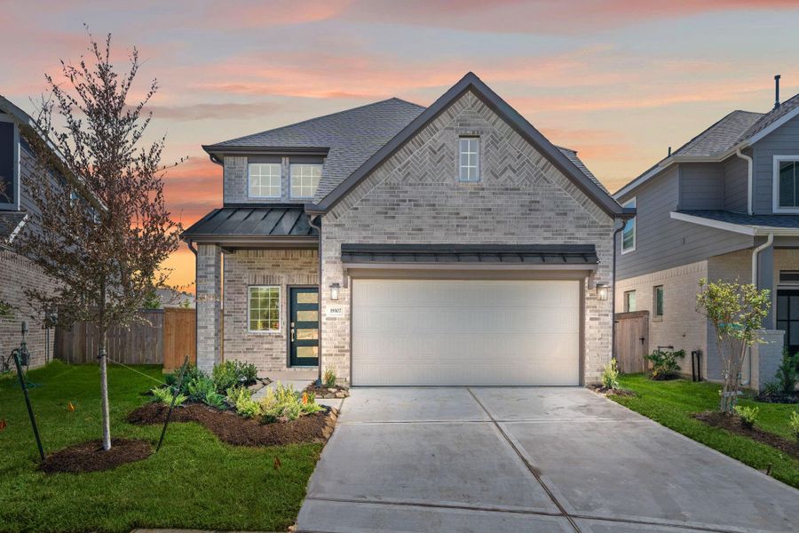 Front exterior of a new home in Emory Glen, Magnolia, TX, highlighting curb appeal (Image 1).