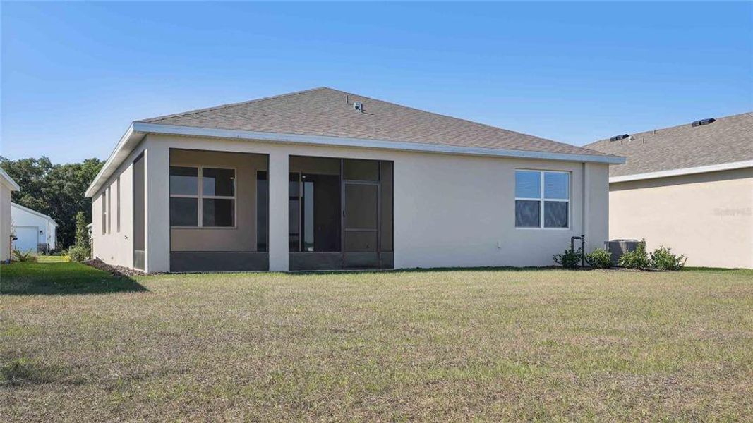 Front exterior of a new home in Twisted Oaks, Wildwood, FL, highlighting curb appeal (Image 1).