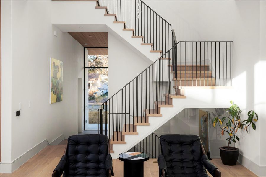 Stairs featuring wood finished floors