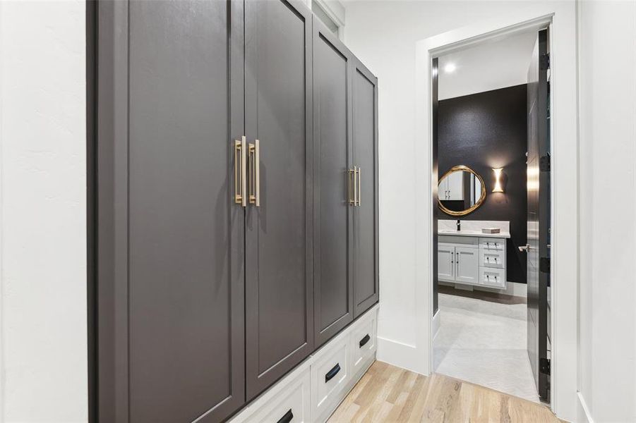 Mudroom featuring sink and light wood-type flooring