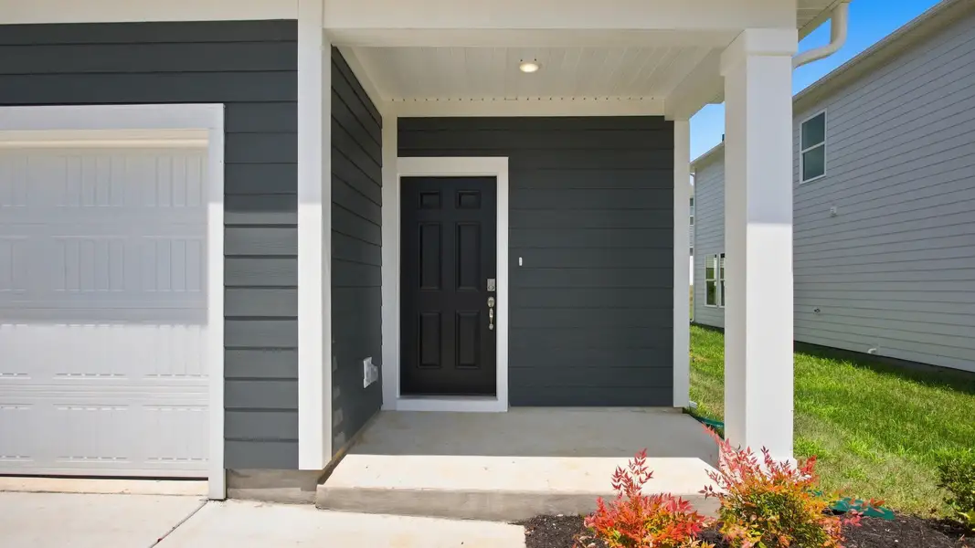 Closer view of front porch with charming black front door