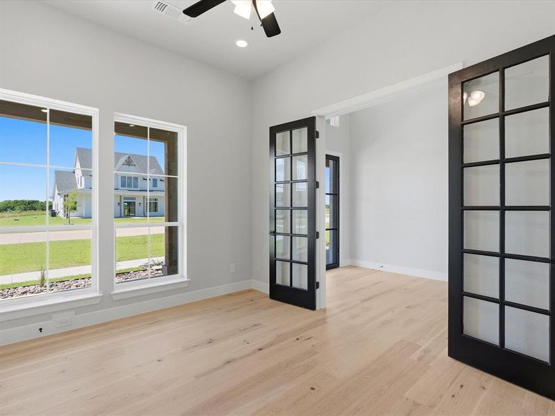 Light wood-finish flooring complements the neutral wall color