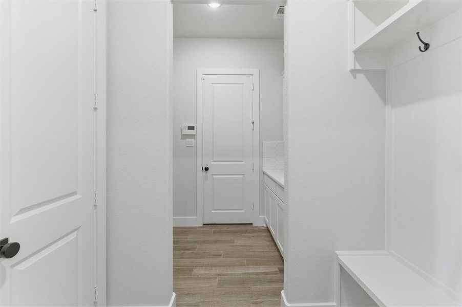 Mudroom with light wood-style floors