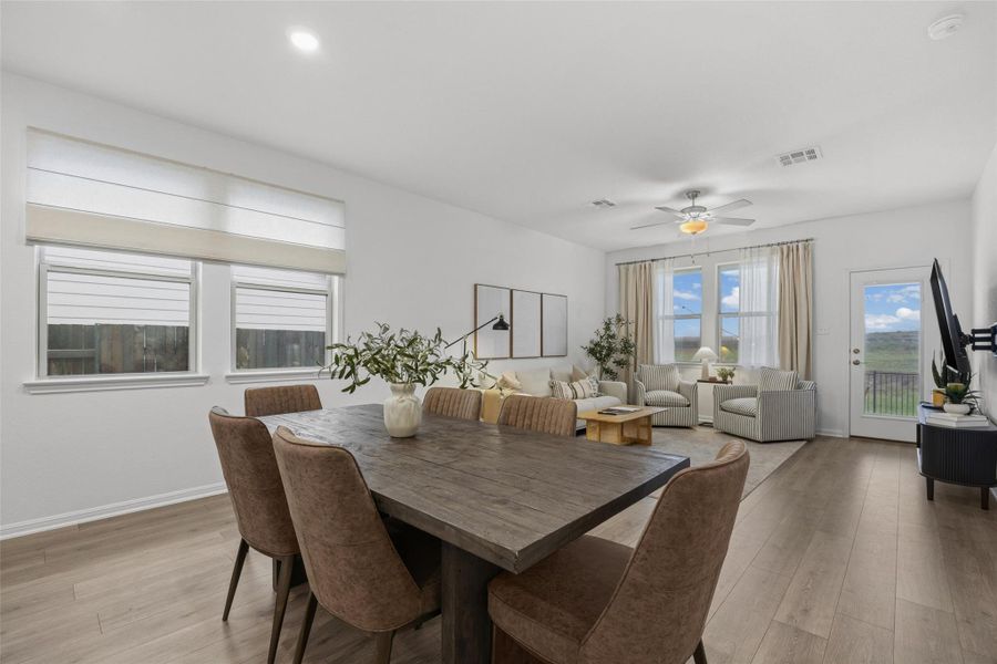 Open-concept living area featuring wood-finish flooring, recessed lighting, and a ceiling fan