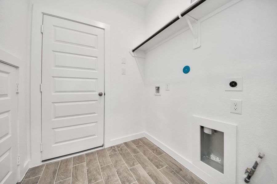 A perfect blend of functionality and comfort. Capture the essence of easy living with a first-floor laundry room, thoughtfully equipped with shelving for effortless organization. Both electric and gas connections available. A perfect blend of functionality and comfort. Capture the essence of easy living with a first-floor laundry room, thoughtfully equipped with shelving for effortless organization. Both electric and gas connections available.