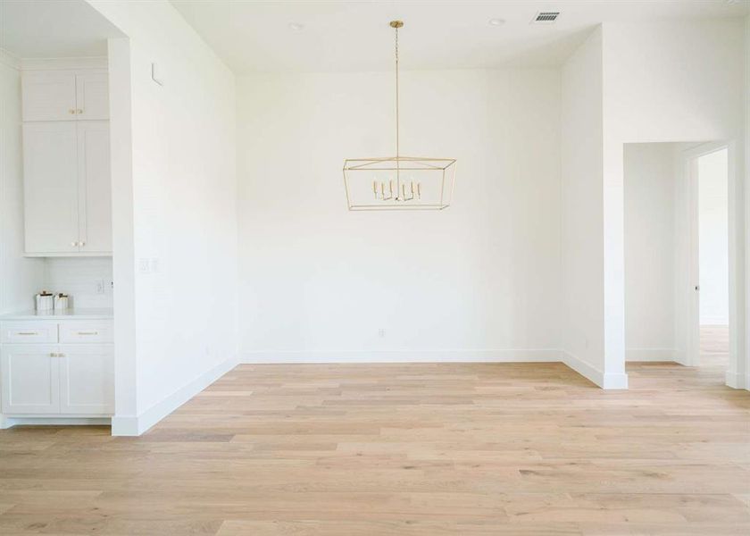 Unfurnished dining area with light wood-type flooring