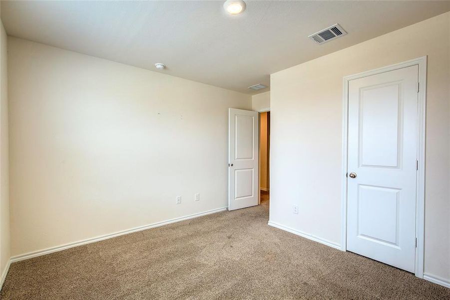 Unfurnished bedroom with carpet floors and baseboards