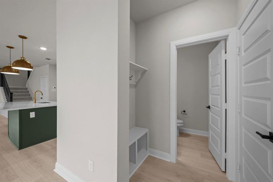 Mudroom with light wood finished floors and recessed lighting