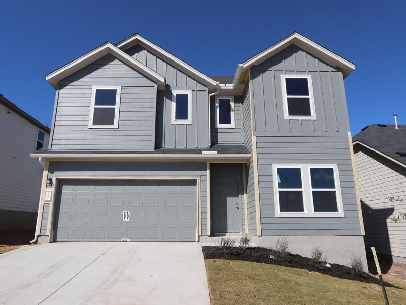 Front exterior of a new home in Cascades at Onion Creek, Austin, TX, highlighting curb appeal (Image 1). Front exterior of a new home in Cascades at Onion Creek, Austin, TX, highlighting curb appeal (Image 1).