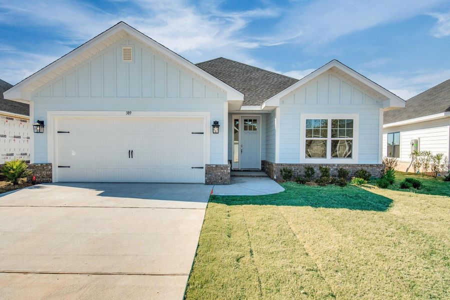 Front exterior of a new home in The Bluffs at Lafayette, Freeport, FL, highlighting curb appeal (Image 1).