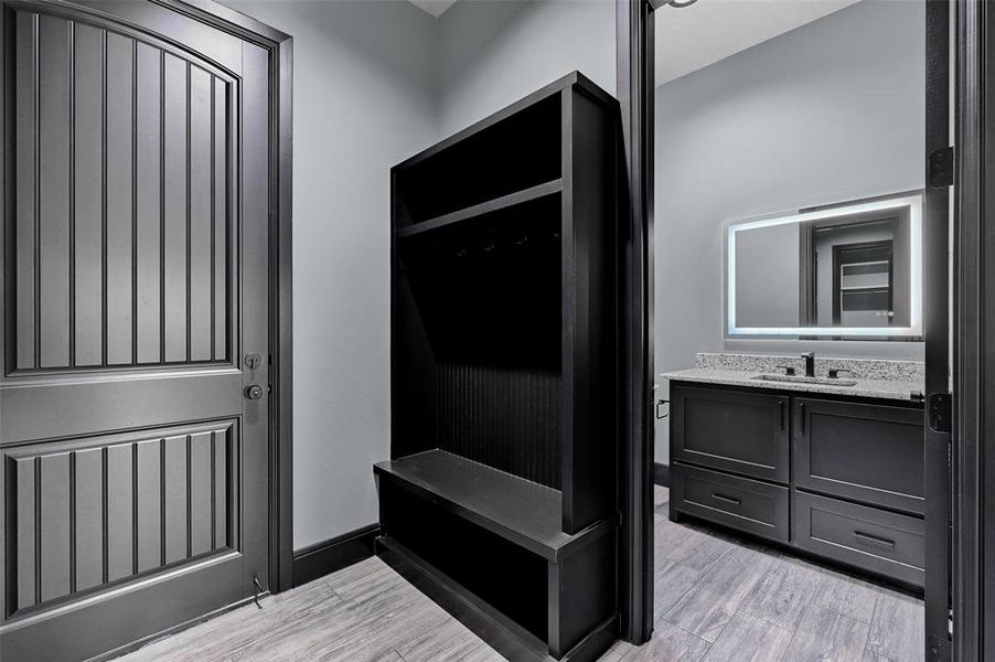 Mudroom featuring a sink and light wood-type flooring Mudroom featuring a sink and light wood-type flooring