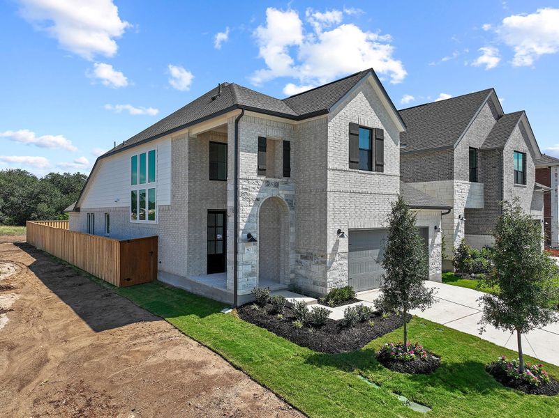 Front exterior of a new home in Parmer Ranch, Georgetown, TX, highlighting curb appeal (Image 23).