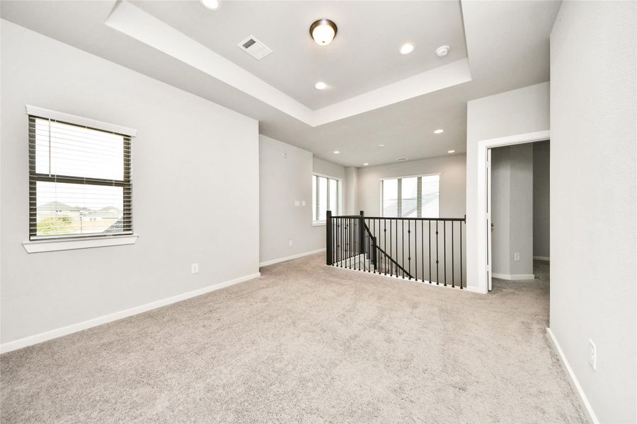 Large upstairs living area or game room with an open layout, natural light, and flexible space for entertaining, relaxing, or working from home.