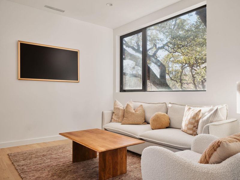 Living room with wood finished floors and baseboards
