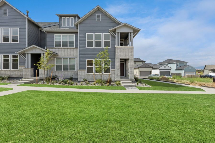 Front exterior of a new home in Kinston Mainstreet Townhomes, Loveland, CO, highlighting curb appeal (Image 2). Front exterior of a new home in Kinston Mainstreet Townhomes, Loveland, CO, highlighting curb appeal (Image 2).