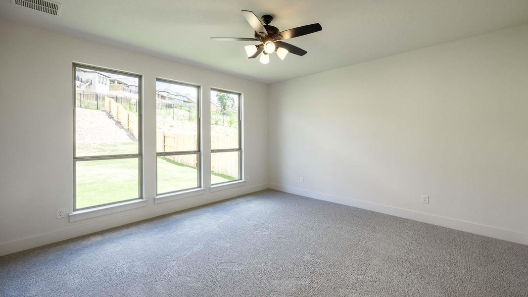 Unfurnished room with ceiling fan and carpet floors