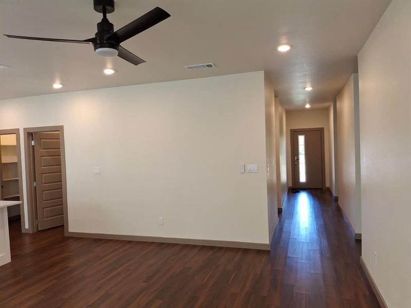 Empty room with dark wood-type flooring, recessed lighting, and ceiling fan Empty room with dark wood-type flooring, recessed lighting, and ceiling fan