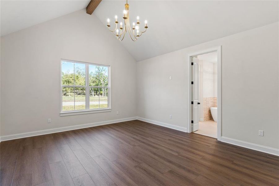 Spare room with dark wood-style floors, beamed ceiling, a chandelier, and high vaulted ceiling