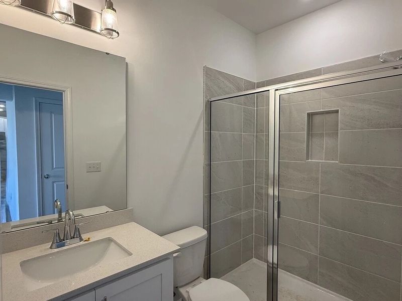 Guest Bath featuring the AW Collection® Coastal - Bright with white cabinets and quartz countertops.