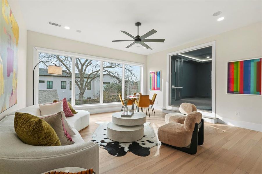 Sitting room with wood finished floors and ceiling fan Sitting room with wood finished floors and ceiling fan