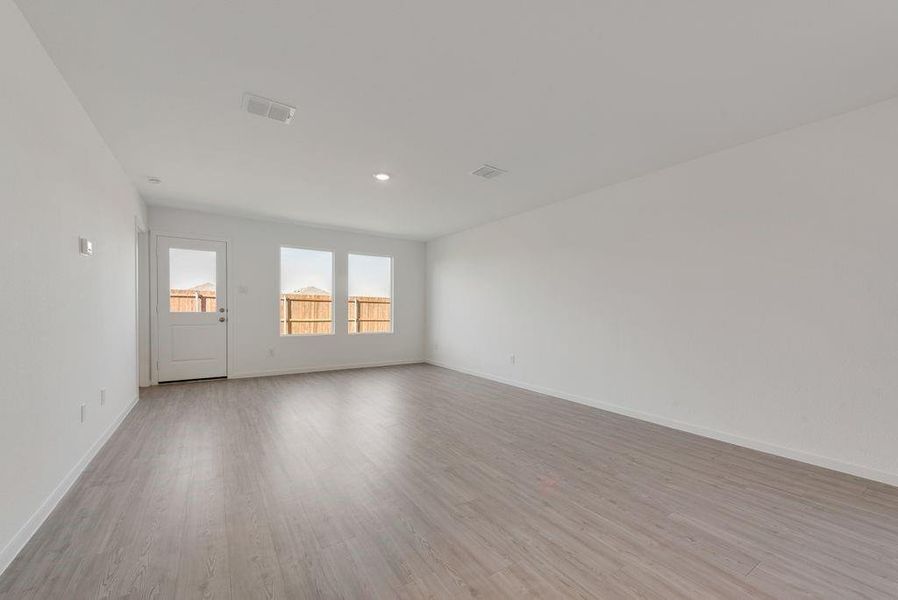 Unfurnished room with light wood finished floors and recessed lighting