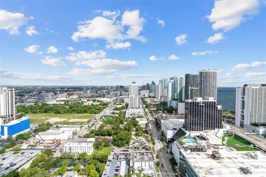 Elevated urban panorama featuring expansive skyline reaches, waterfront proximity, and metropolitan streetscapes