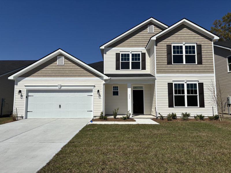 Front exterior of a new home in Settlers Hammock, Kingsland, GA, highlighting curb appeal (Image 1). Front exterior of a new home in Settlers Hammock, Kingsland, GA, highlighting curb appeal (Image 1).
