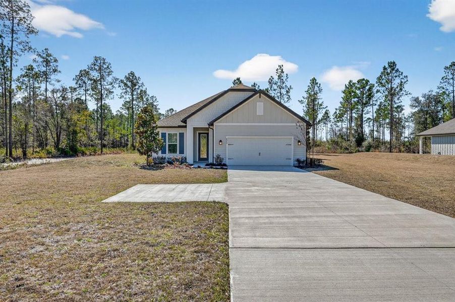 Front exterior of a new home in Stables at Cary Forest, Bryceville, FL, highlighting curb appeal (Image 24).