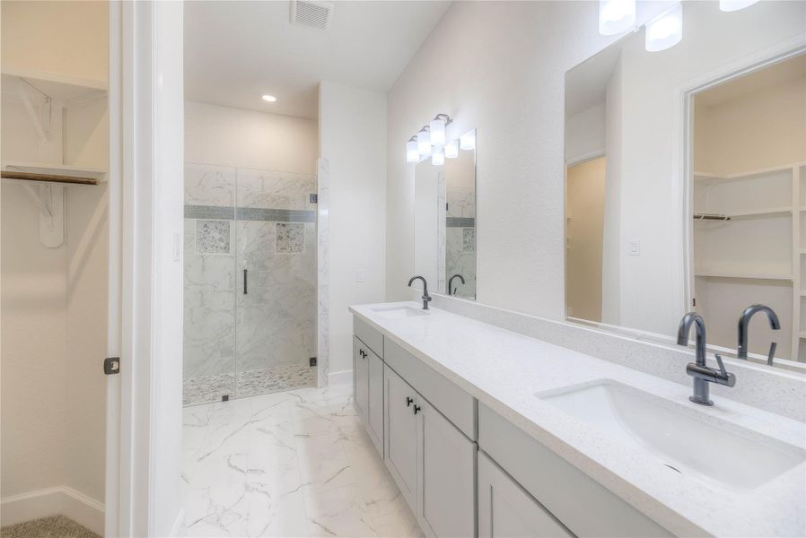 Features of the primary bath include closet double sinks, custom tile walk-in shower and a walk-in closet.