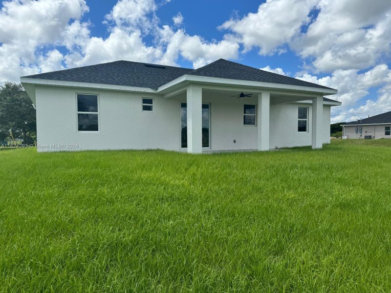 Front exterior of a new home in , Lehigh Acres, FL, highlighting curb appeal (Image 8).