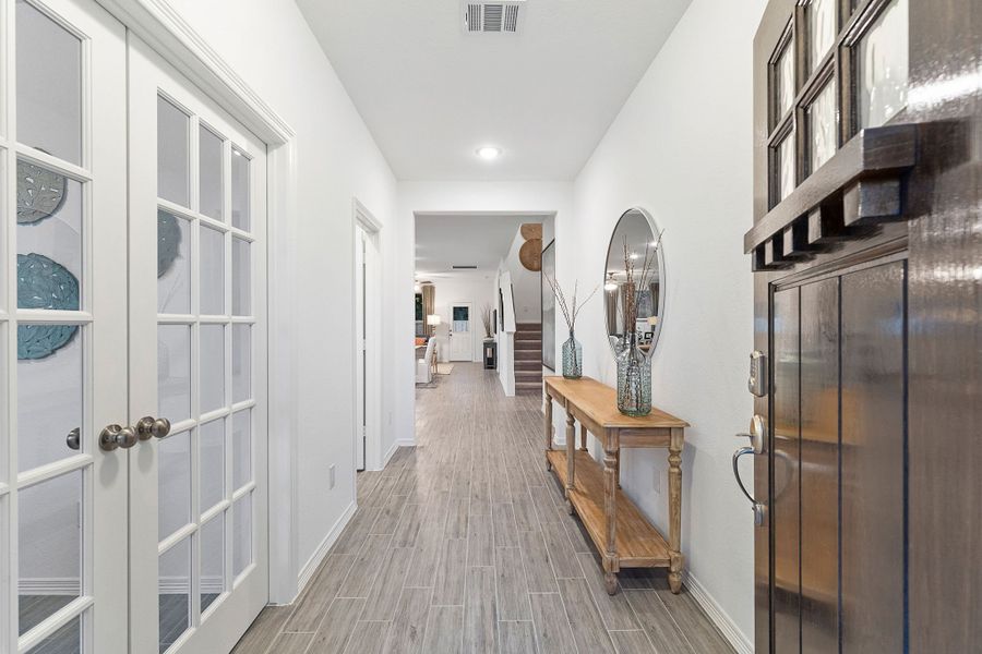 A long hallway with white doors. A long hallway with white doors.