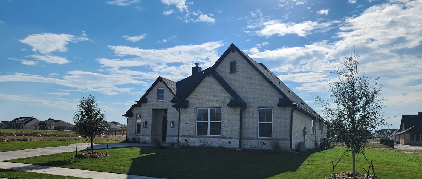 Front exterior of a new home in Paloma Ranches, Justin, TX, highlighting curb appeal (Image 2). Front exterior of a new home in Paloma Ranches, Justin, TX, highlighting curb appeal (Image 2).