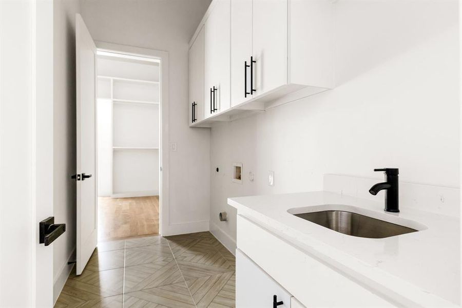 Washroom with electric dryer hookup, cabinet space, and washer hookup Washroom with electric dryer hookup, cabinet space, and washer hookup