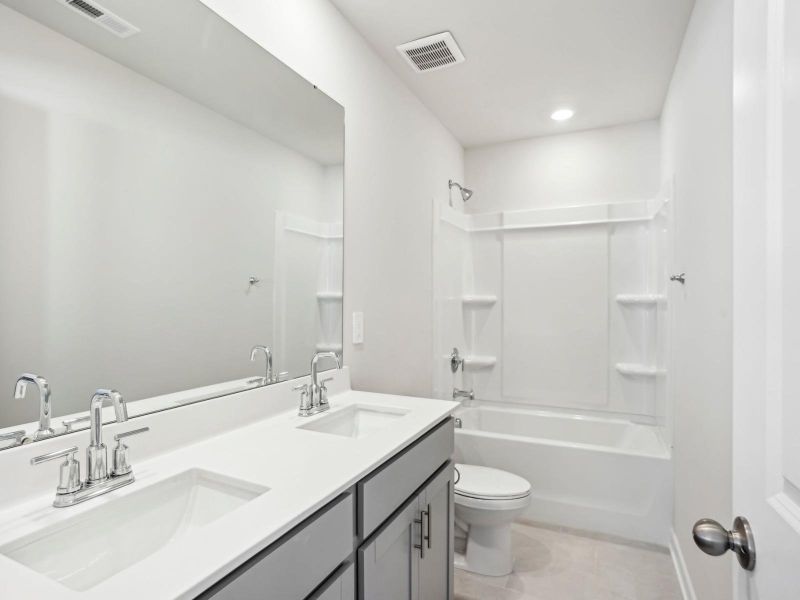 Our secondary bathroom features an oversized tub and mirror. Our secondary bathroom features an oversized tub and mirror.