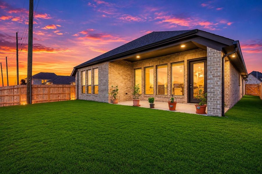Enjoy relaxing evenings outdoors under the covered patio, an inviting space perfect for entertaining, outdoor dining, or unwinding while taking in the private backyard setting. Twilight enhanced photo Enjoy relaxing evenings outdoors under the covered patio, an inviting space perfect for entertaining, outdoor dining, or unwinding while taking in the private backyard setting. Twilight enhanced photo