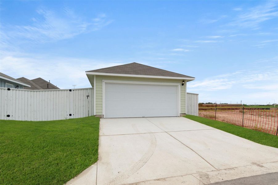 Garage featuring driveway Garage featuring driveway