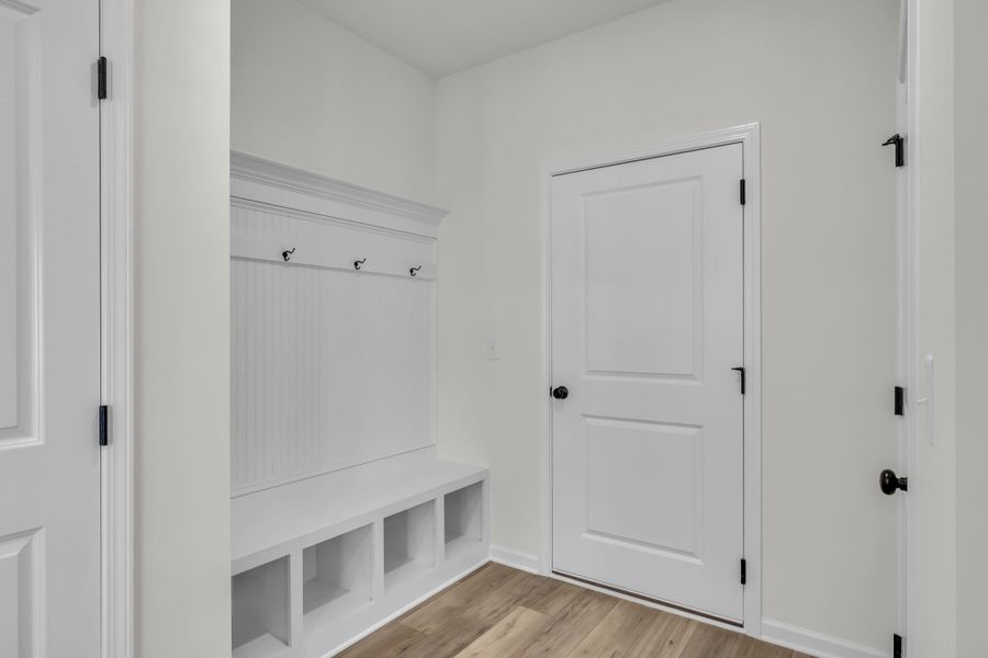 Mudroom area off the garage with a build in mudroom bench!