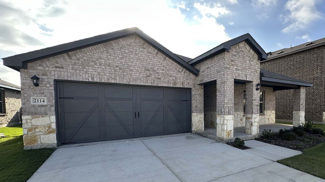 Front exterior of a new home in Cartwright Ranch, Crandall, TX, highlighting curb appeal (Image 2). Front exterior of a new home in Cartwright Ranch, Crandall, TX, highlighting curb appeal (Image 2).