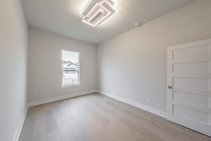 Unfurnished room with light wood-style flooring and cooling unit