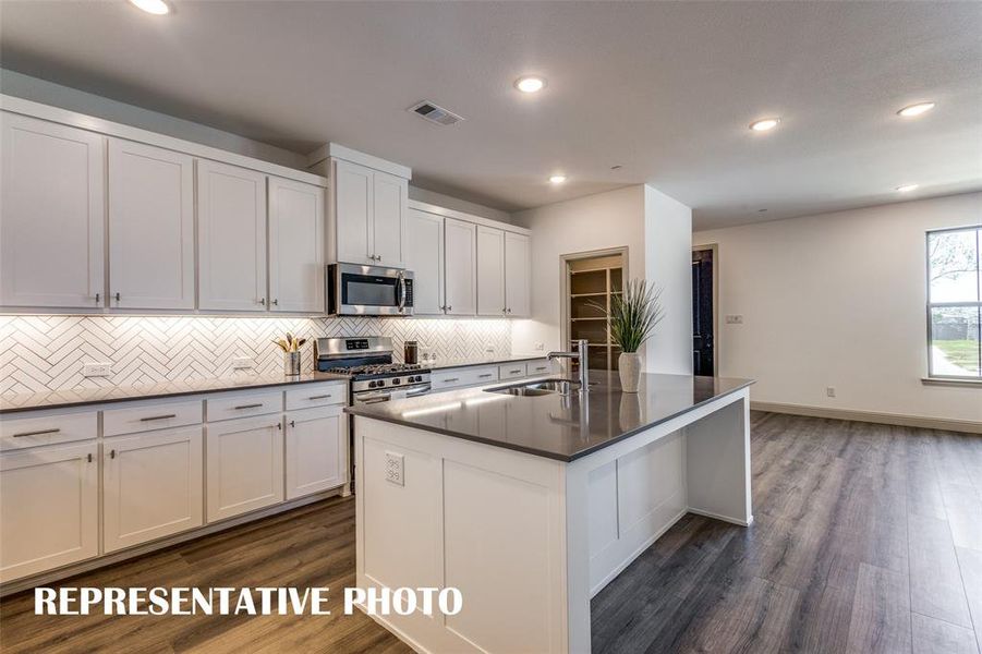 With ample storage and prep space, this kitchen offers everything you have been searching for in a dream kitchen!  REPRESENTATIVE PHOTO.