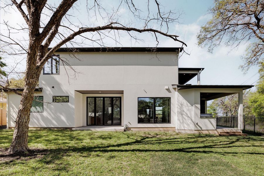 The rear exterior showcases the home’s architectural presence, set against a backdrop of mature trees and greenbelt. Ask the agent about an approved pool concept. The rear exterior showcases the home’s architectural presence, set against a backdrop of mature trees and greenbelt. Ask the agent about an approved pool concept.