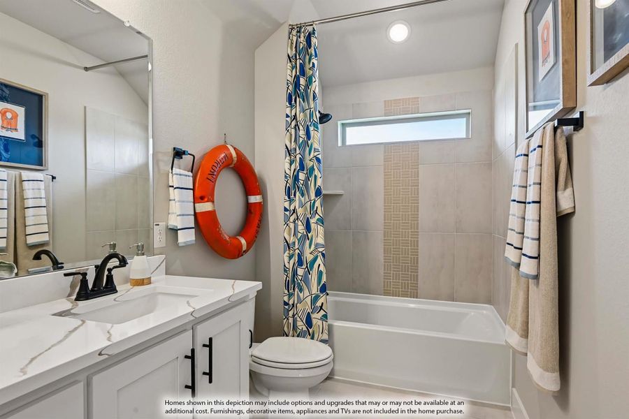 Bathroom with white vanity, tiled tub-shower combo, and nautical decor accents Bathroom with white vanity, tiled tub-shower combo, and nautical decor accents