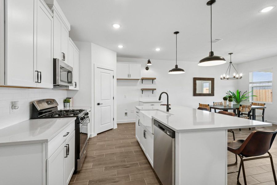Lovely kitchen with white cabinets and quartz counters