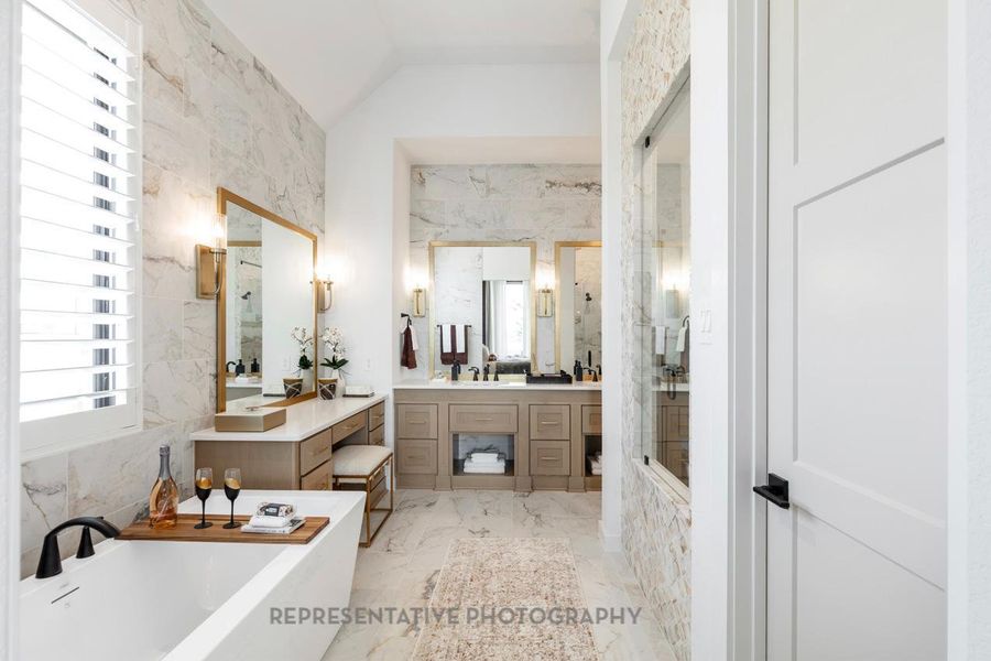 Bathroom with a freestanding tub, vanity, a shower stall, marble finish floors, and lofted ceiling Bathroom with a freestanding tub, vanity, a shower stall, marble finish floors, and lofted ceiling