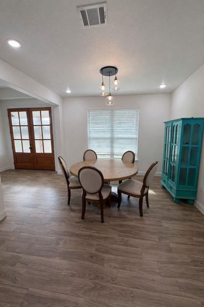 Dining space with french doors, wood finished floors, healthy amount of natural light, and recessed lighting Dining space with french doors, wood finished floors, healthy amount of natural light, and recessed lighting