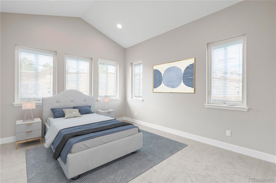 Main level guest bedroom with en suite bathroom and walk-in closet. *This photo has been virtually staged.